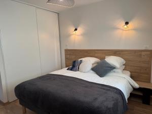 a bedroom with a large bed with two pillows at The Eagle's Nest - cosy chalet for two in Jarjayes