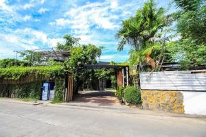 an empty street with a building with a gate at OYO 271 The Resort Romklao in Bangkok