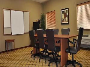 einen Konferenzraum mit einem langen Holztisch und Stühlen in der Unterkunft Candlewood Suites Springfield By IHG in Southlawn