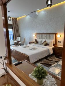 a bedroom with a large bed and a large mirror at IDGA appartement with panoramic view in Chefchaouen