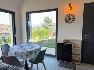 a dining room with a table and chairs and a window at The Nest - cosy chalet for two in Jarjayes