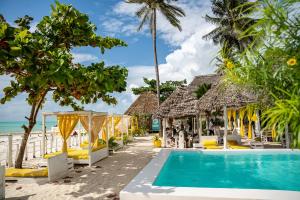 a resort with a swimming pool and a beach at ZAN Uhuru Jambiani Beach in Bwejuu