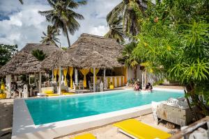 a swimming pool in front of a resort at ZAN Uhuru Jambiani Beach in Bwejuu +42 photos