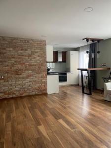 a living room with a brick wall and a table at TK apartamenti 3 in Rēzekne