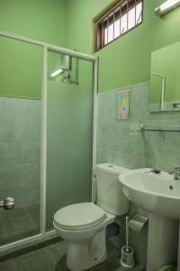 a bathroom with a toilet and a sink and a shower at Self Cate Luxury Apartments in Kandy +70 photos