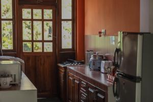a kitchen with a refrigerator and a counter top at Self Cate Luxury Apartments in Kandy
