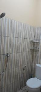 a bathroom with a shower and a toilet at Arsya kost homestay in Balikpapan