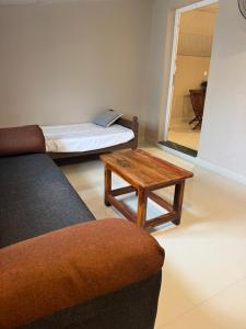 a living room with two beds and a table at Jp Resorts in Muttupet
