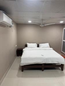 a bedroom with a large bed with a ceiling at Jp Resorts in Muttupet