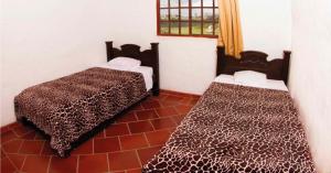 a bedroom with two beds in a room at Hacienda Sanmiguel de la Prada in Los Santos