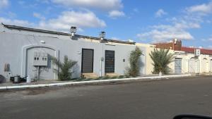 a white building on the side of a street at شاليه ايلان المدينة المنورة in Medina