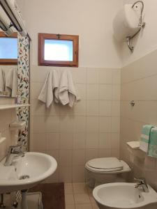 een witte badkamer met een toilet en een wastafel bij La Villetta in Vittorito +7 foto's