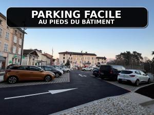 a street with cars parked in a parking lot at Le Cocon 54 Studio à Rives Parking facile in Rives