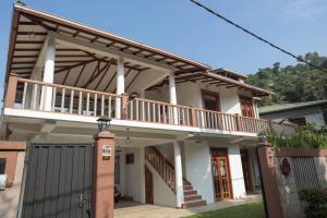 a house with a balcony on top of it at Self Cate Luxury Apartments in Kandy
