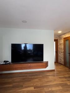 a large flat screen tv on a white wall at TK apartamenti 3 in Rēzekne