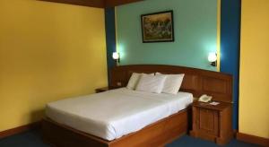 a bedroom with a bed and a phone on a table at Athaya Hotel Kendari in Pipulu +171 photos