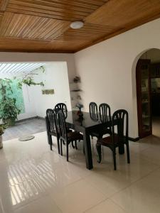 a dining room with a black table and chairs at JHome in Kurunegala