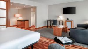 a hotel room with a bed and a living room at AC Hotel La Rioja by Marriott in Logroño