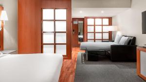a hotel room with a bed and a living room at AC Hotel La Rioja by Marriott in Logroño