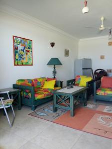 a living room with two couches and a table at Chalet On the Beach in Alexandria