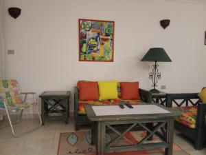 a living room with a couch and a table at Chalet On the Beach in Alexandria +5 photos