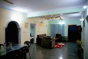 a living room with a couch and a table at WildWood Stay in Madikeri
