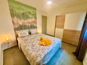 a bedroom with a bed with a large painting on the wall at LA RDC Villa 3 ch jacuzzi Saint-Pierre in Saint-Pierre
