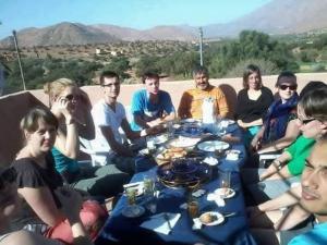 a group of people sitting around a table at Auberge Gitelkst in Tafraout +48 photos