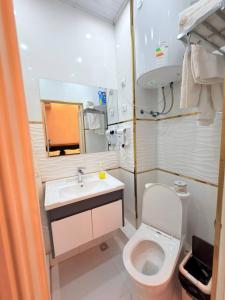 a small bathroom with a toilet and a sink at Soro Hotel in Dushanbe