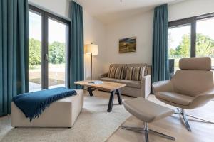 a living room with a couch chair and a table at Ferienhaus Baltic in Lobbe in Lobbe