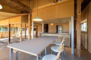 a kitchen with a large white table and chairs at ICHI -en- in Fujikawaguchiko