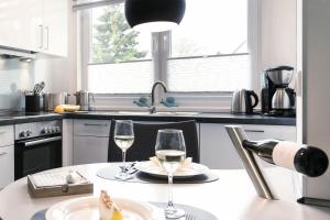 a kitchen with two glasses of wine on a table at Villa Wiederkehr Einkehr in Ostseebad Sellin