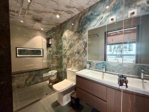 a bathroom with a toilet and a sink at Navasharada's White Sand Beach House in Udupi +29 photos