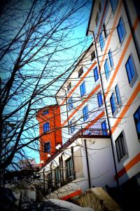 ein orangefarbenes und weißes Gebäude mit blauen Fenstern in der Unterkunft Hotel Iris in Roccaraso