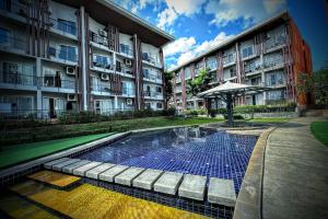 a swimming pool in front of a building at Z Loft Seaside FutureJungle Loft in Nathon Bay