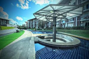 an umbrella sitting on top of a pool next to a building at Z Loft Seaside FutureJungle Loft in Nathon Bay