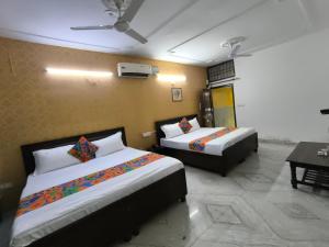 a hotel room with two beds and a table at Hotel the diamond Ring in Chandīgarh