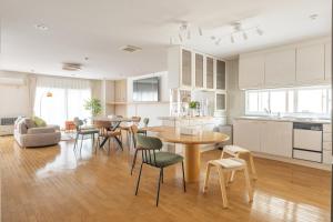 a kitchen and living room with a table and chairs at Cozy Stay Kamui in Asahikawa