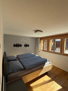 una camera da letto con un letto con cuscini blu di Larix a Ulrichen
