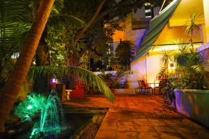 a fountain in the middle of a courtyard at night at Casa del Caribe Inn in San Juan