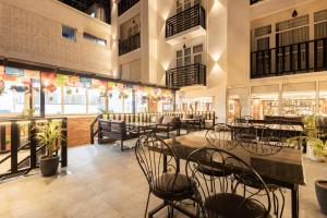 a restaurant with tables and chairs in a building at Tulsi Kathmandu Hotel in Kathmandu