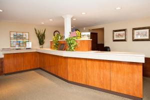 a lobby with a reception counter with an american flag at Blue Rock Resort in South Yarmouth