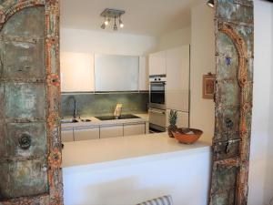 a kitchen with an old rusty door in a room at Residenza Golf Parco by Fewotessin in Ascona