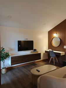 a living room with a tv and a couch at Tangerine Villa Patong in Patong Beach