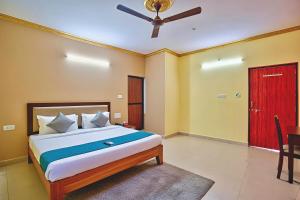 a bedroom with a bed and a red door at RAIAl DWELLING PLACE in Calangute