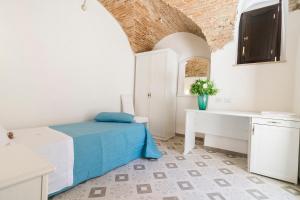 a bedroom with a bed and a desk in a room at Residenza La Nivera in Miglionico