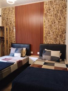 Postel nebo postele na pokoji v ubytování D'corner Homestay