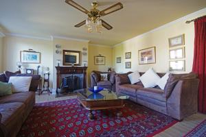 a living room with couches and a ceiling fan at Buddha Villa in Arillas