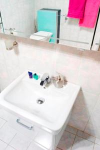 a white sink in a bathroom with a mirror at Sleep and Go in Minden