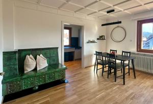 a dining room with a green cabinet and a table at Apartment 22 in Schlins